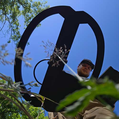 Person holding a metal detector VLF coil
